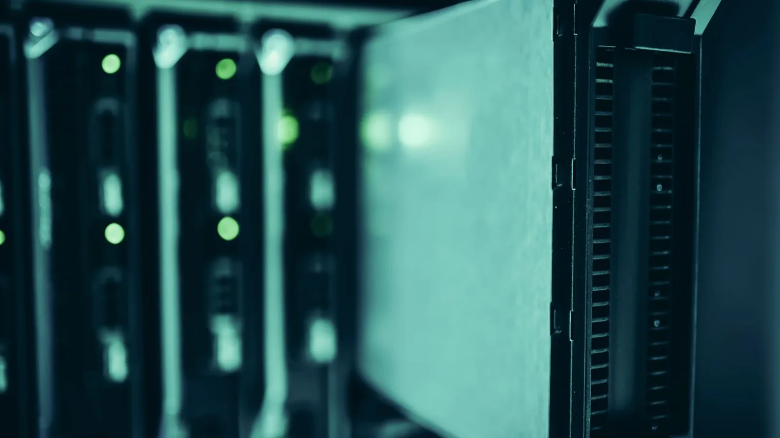 A drive sliding out of a server rack in a data center, mid-swap.